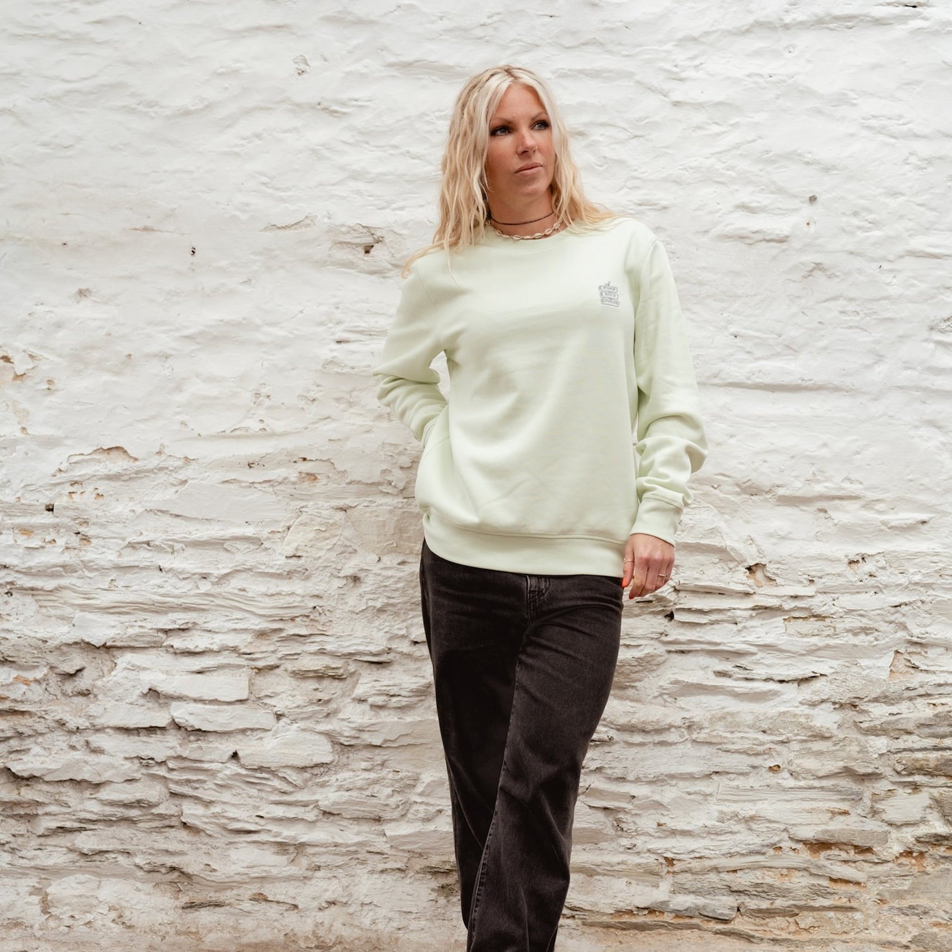 Female model wearing the "Minty" light green Boulevard crewneck sweatshirt with Surf City Cycles chest logo.