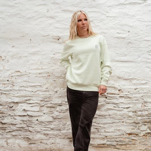 Female model wearing the "Minty" light green Boulevard crewneck sweatshirt with Surf City Cycles chest logo.