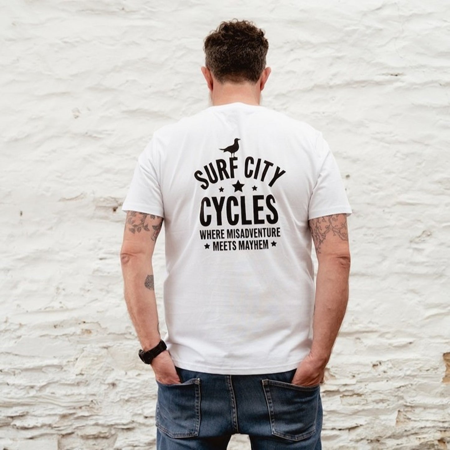 Close-up of the hand-drawn style skeleton rider graphic on a white cotton t-shirt.