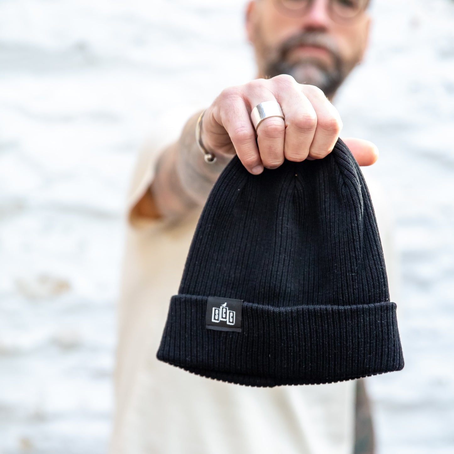 The Seafarer Organic Ribbed Beanie in Black, featuring the Surf City Cycles SCC woven clip label.