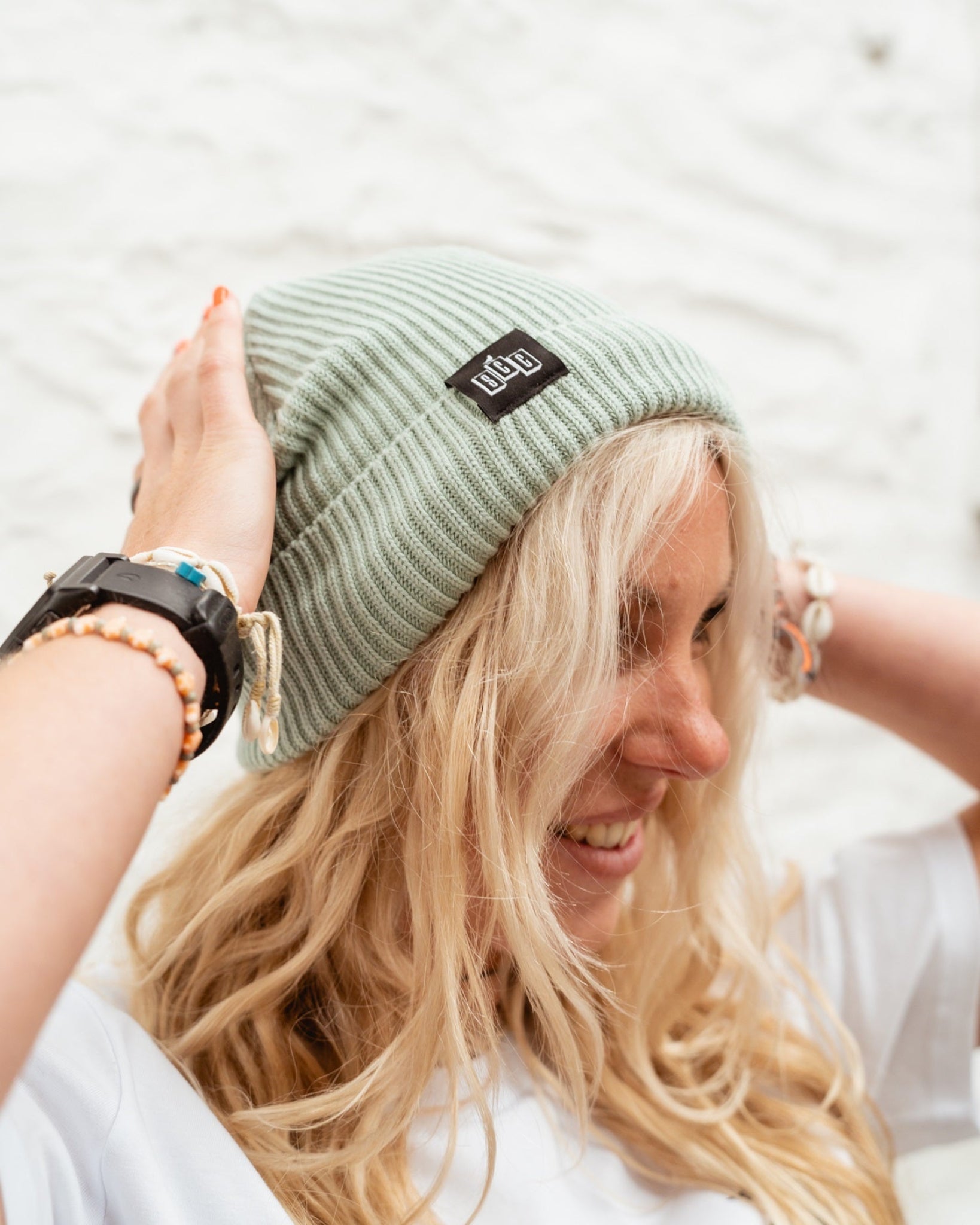 Surf City Cycles beanie worn by smiling model outdoors, lifestyle shot, unisex