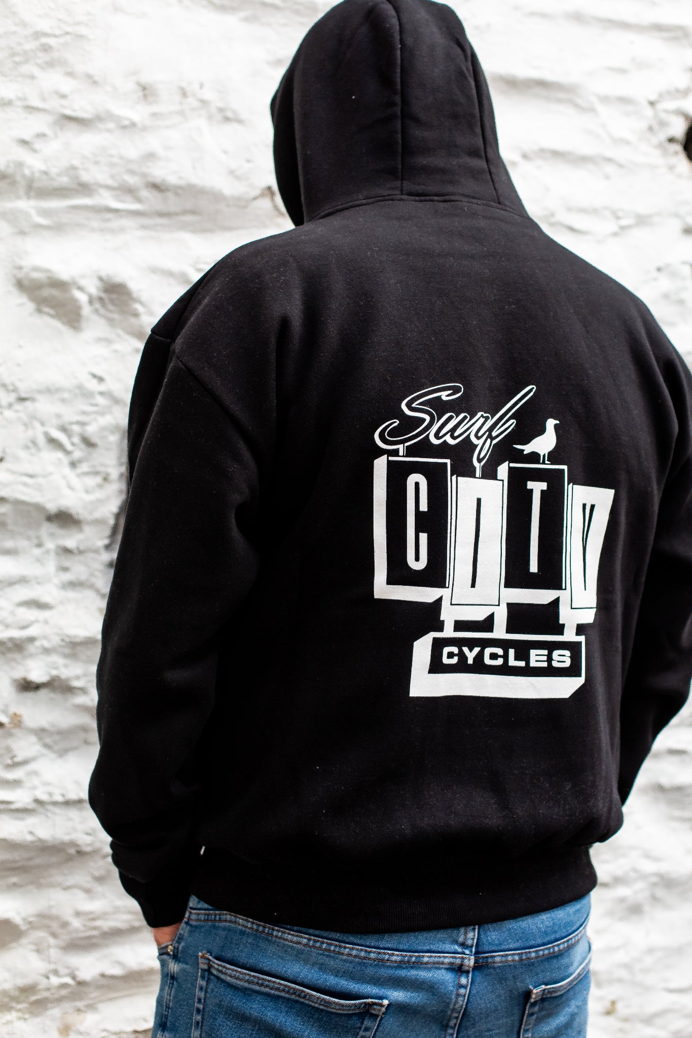 Black pullover hoodie by Surf City Cycles, back view, cotton fleece, unisex