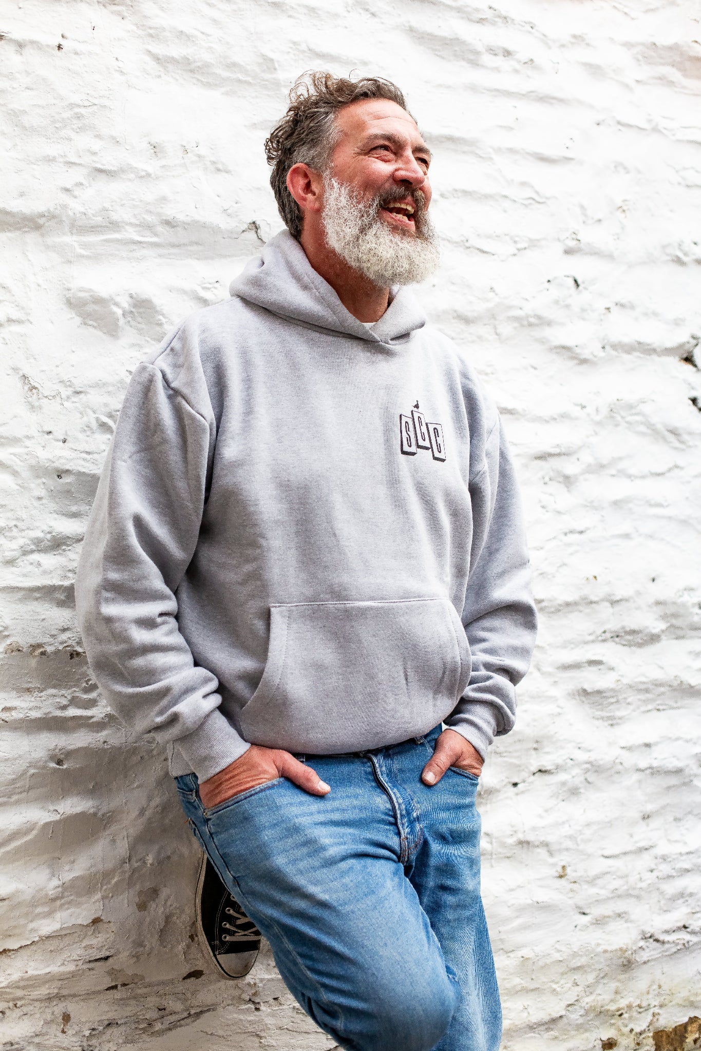 Heather Grey pullover hoodie by Surf City Cycles worn casually, surf-moto inspired clothing