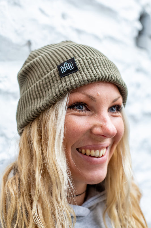 Surf City Cycles beanie worn by smiling model outdoors, lifestyle shot, unisex