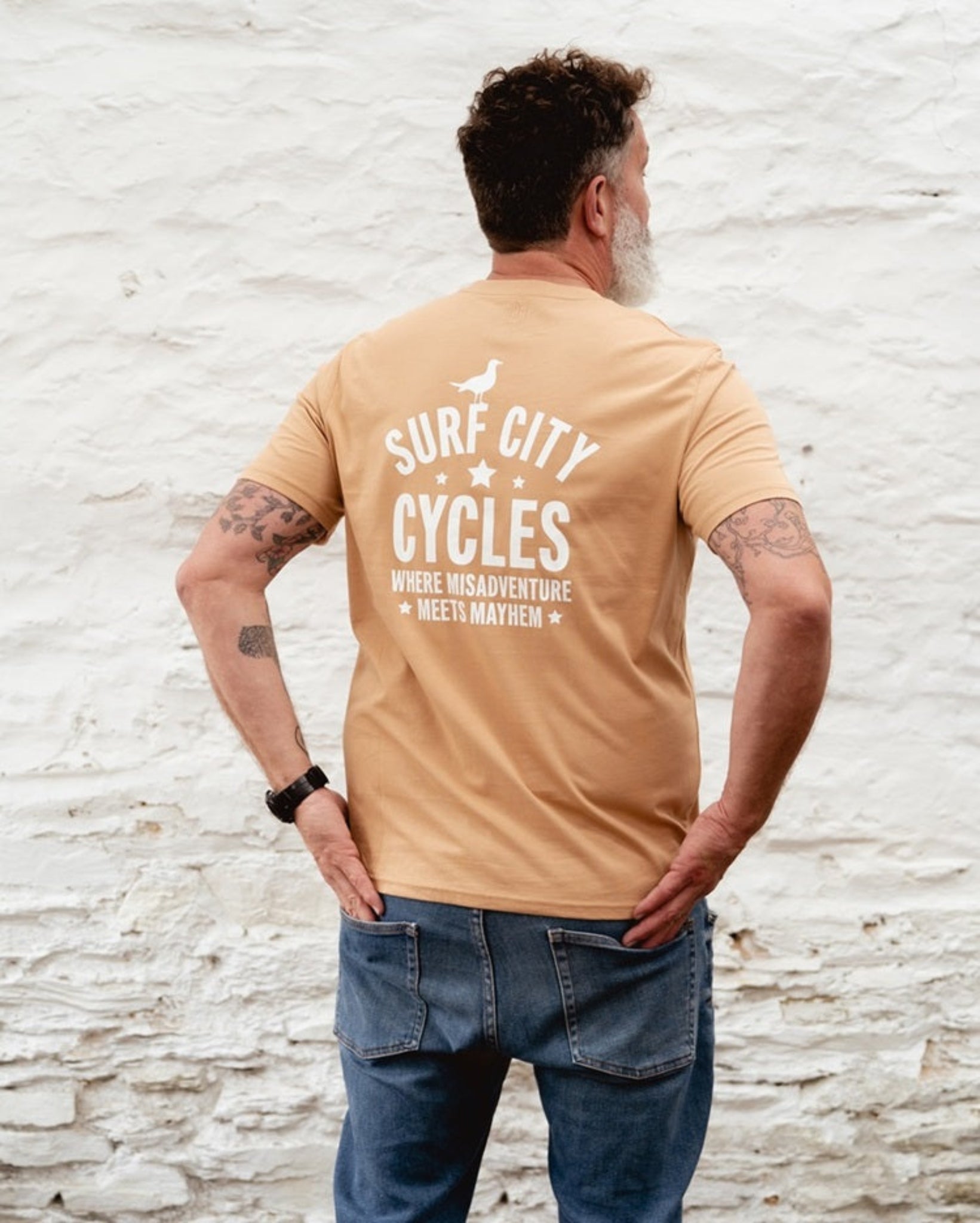 Latte Surf City Cycles Misadventure T-shirt back view worn by male model