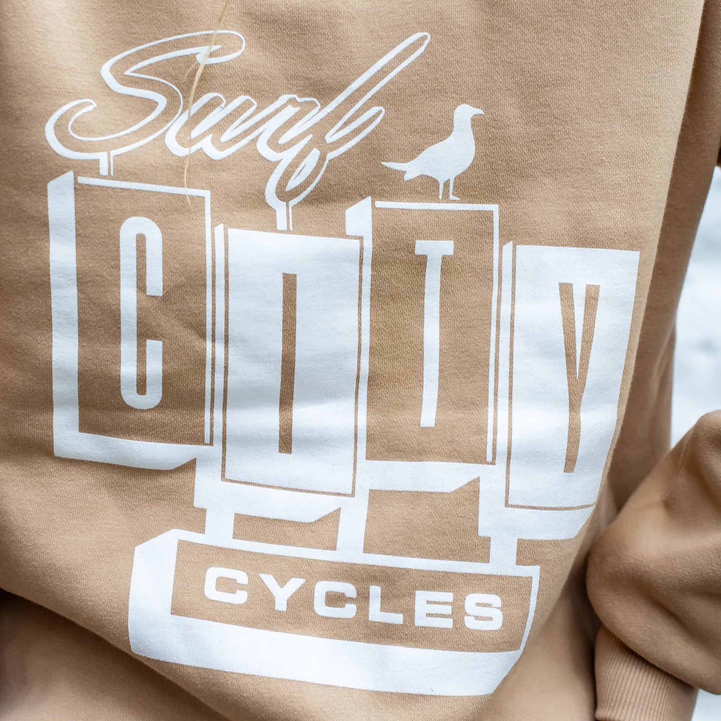 Profile view of Andrew Pringle wearing the Desert Sand heavyweight hoodie, highlighting the structured fit and warm neutral tone.