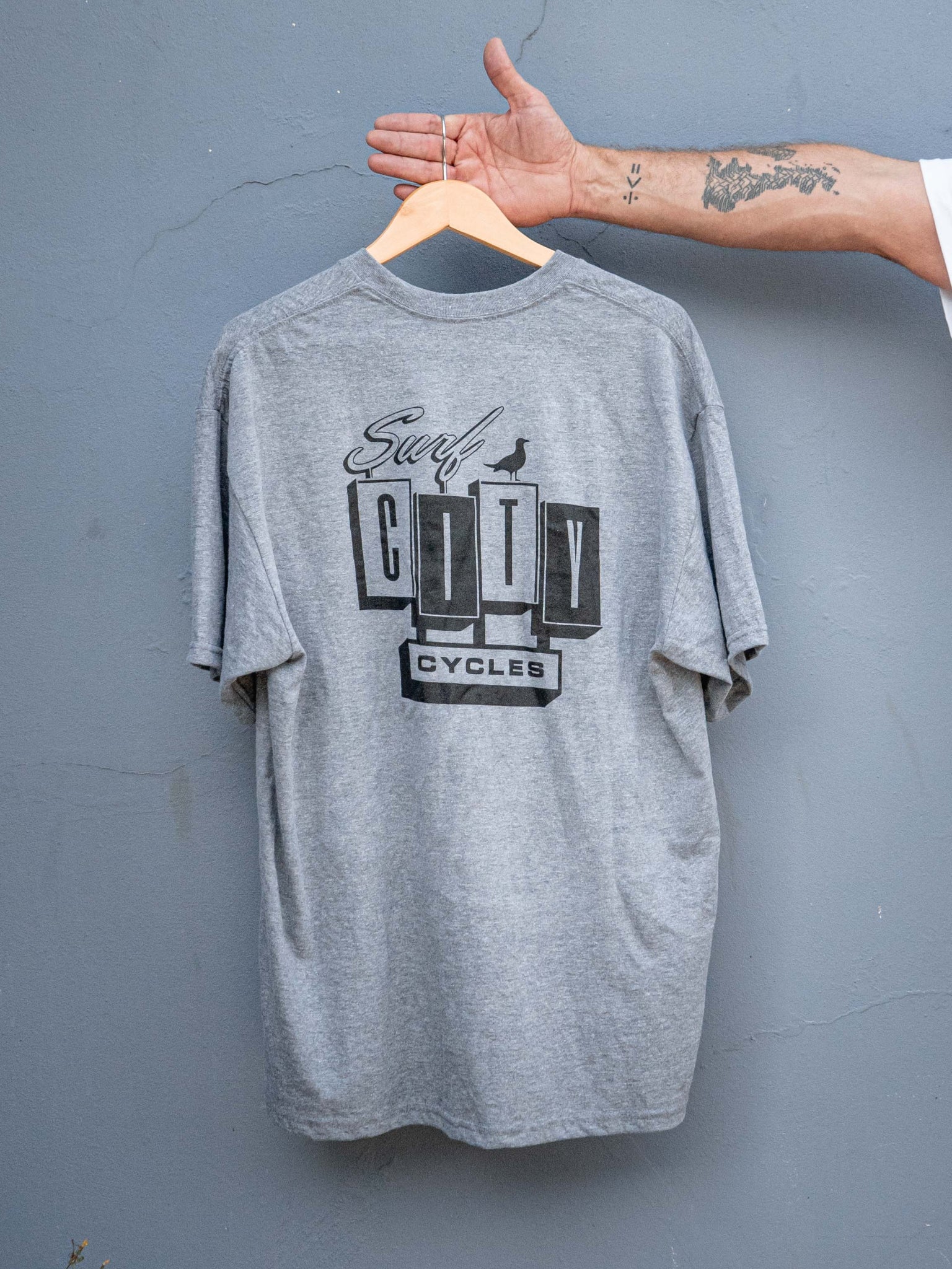 Heather grey OG Logo short sleeve tee by Surf City Cycles, back view, unisex