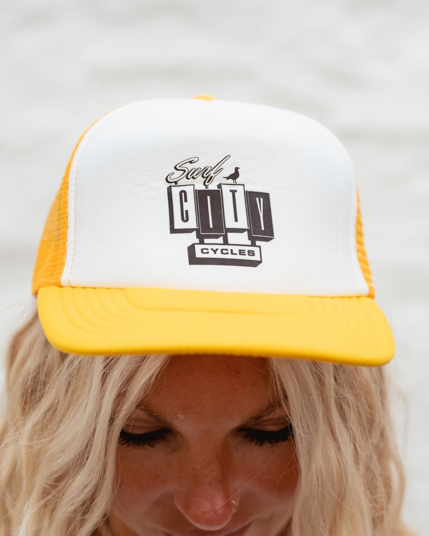 Yellow and white OG Logo trucker cap by Surf City Cycles, front view, unisex