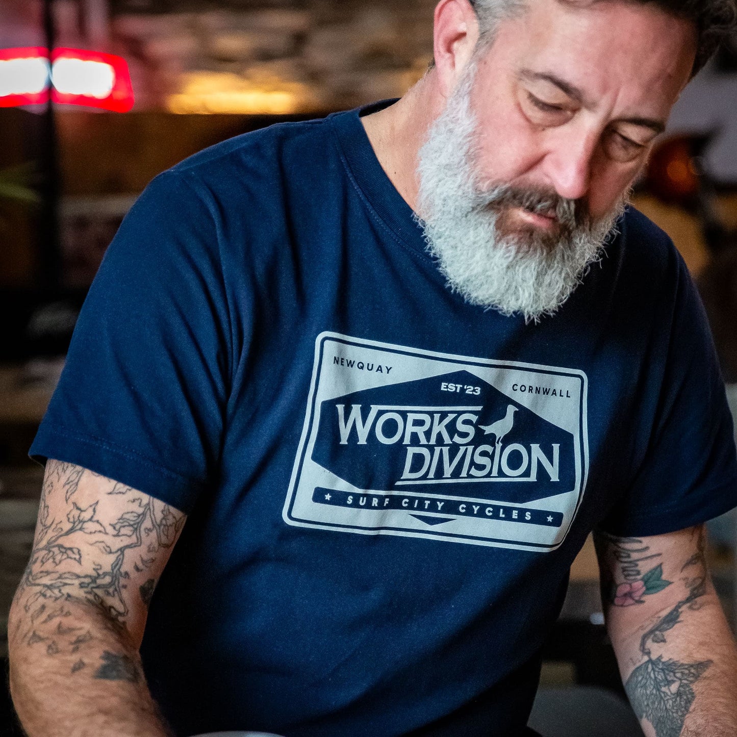 lose-up of the Navy Heavy Duty Utility Tee from the Works Division, featuring the Surf City Cycles workshop graphic.