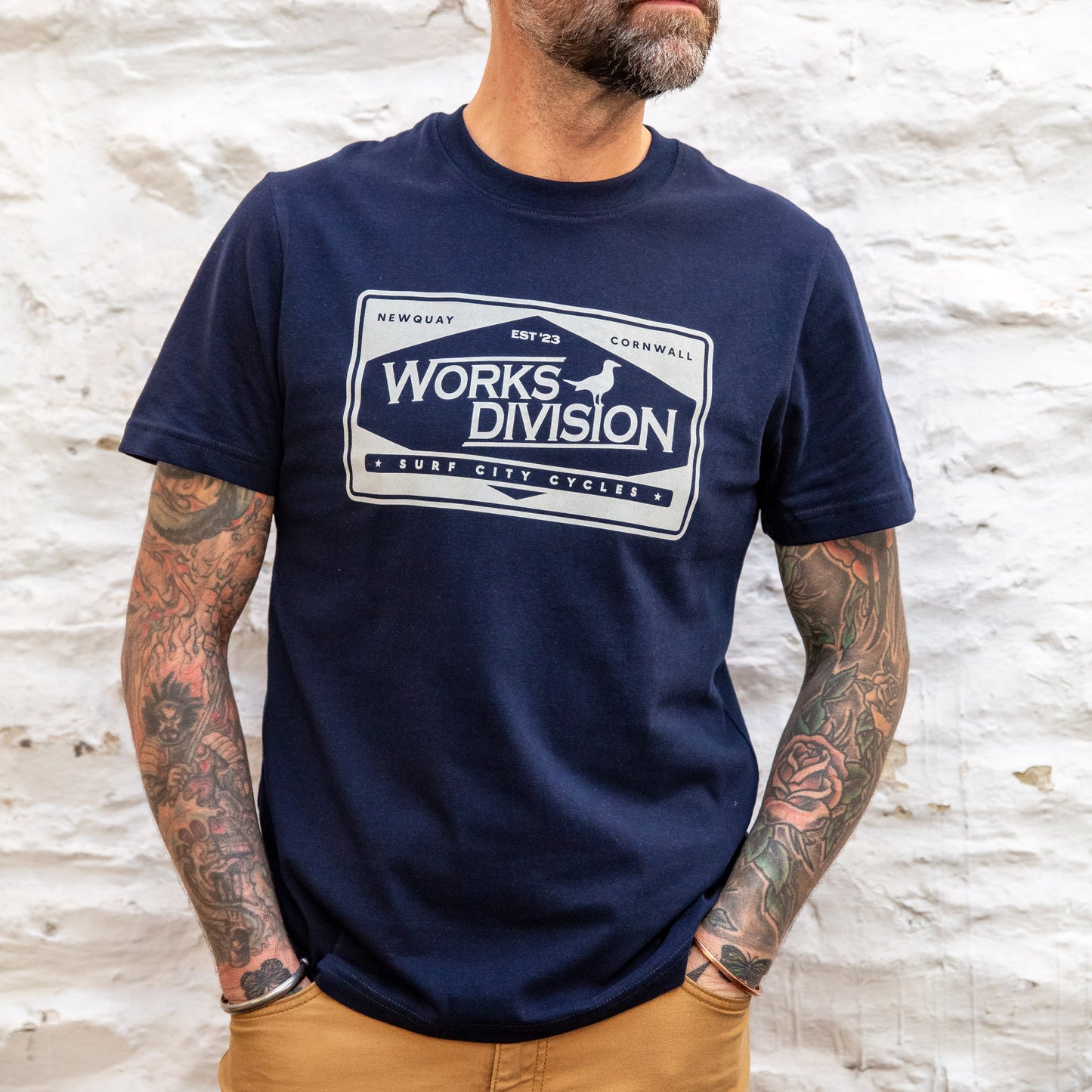Close-up of the Navy Works Division Heavy Utility Tee featuring the workshop chest graphic on a male model.