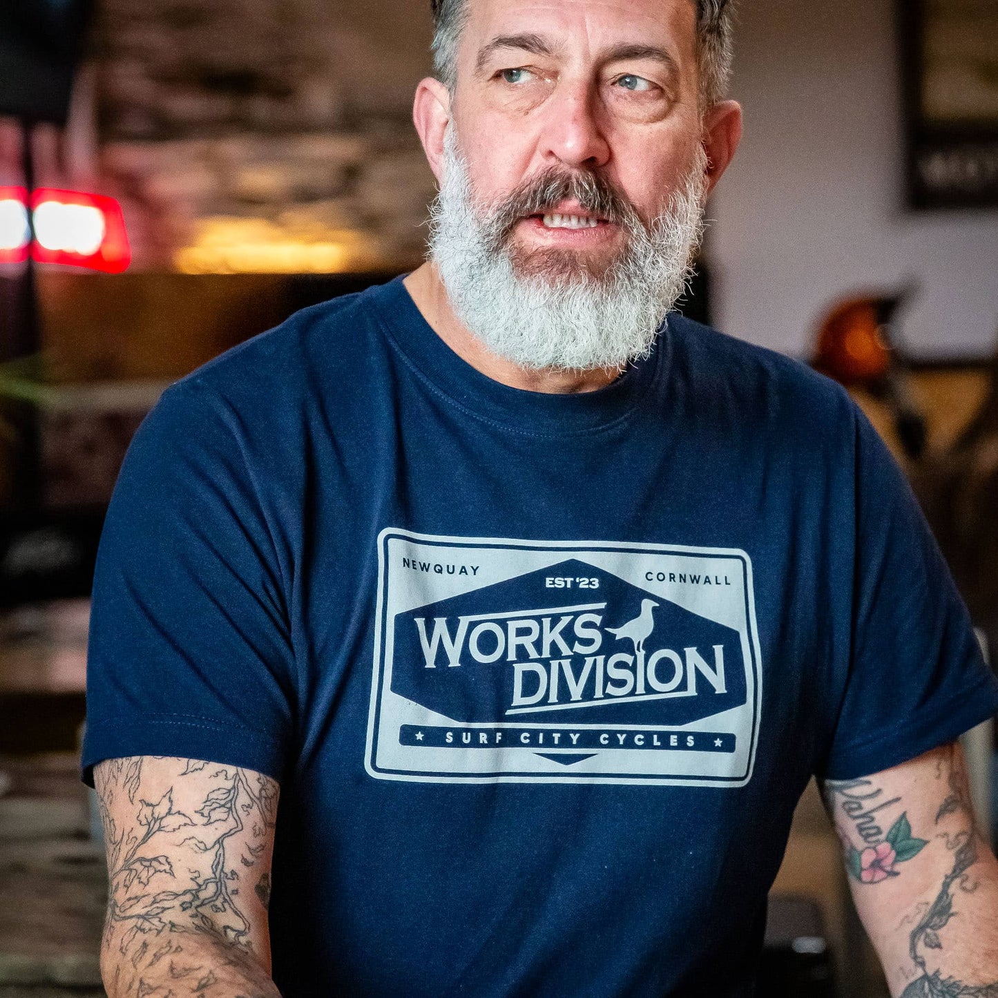 A lifestyle shot of the Navy Works Division Heavy Utility Tee worn while driving a classic truck, highlighting the relaxed fit.
