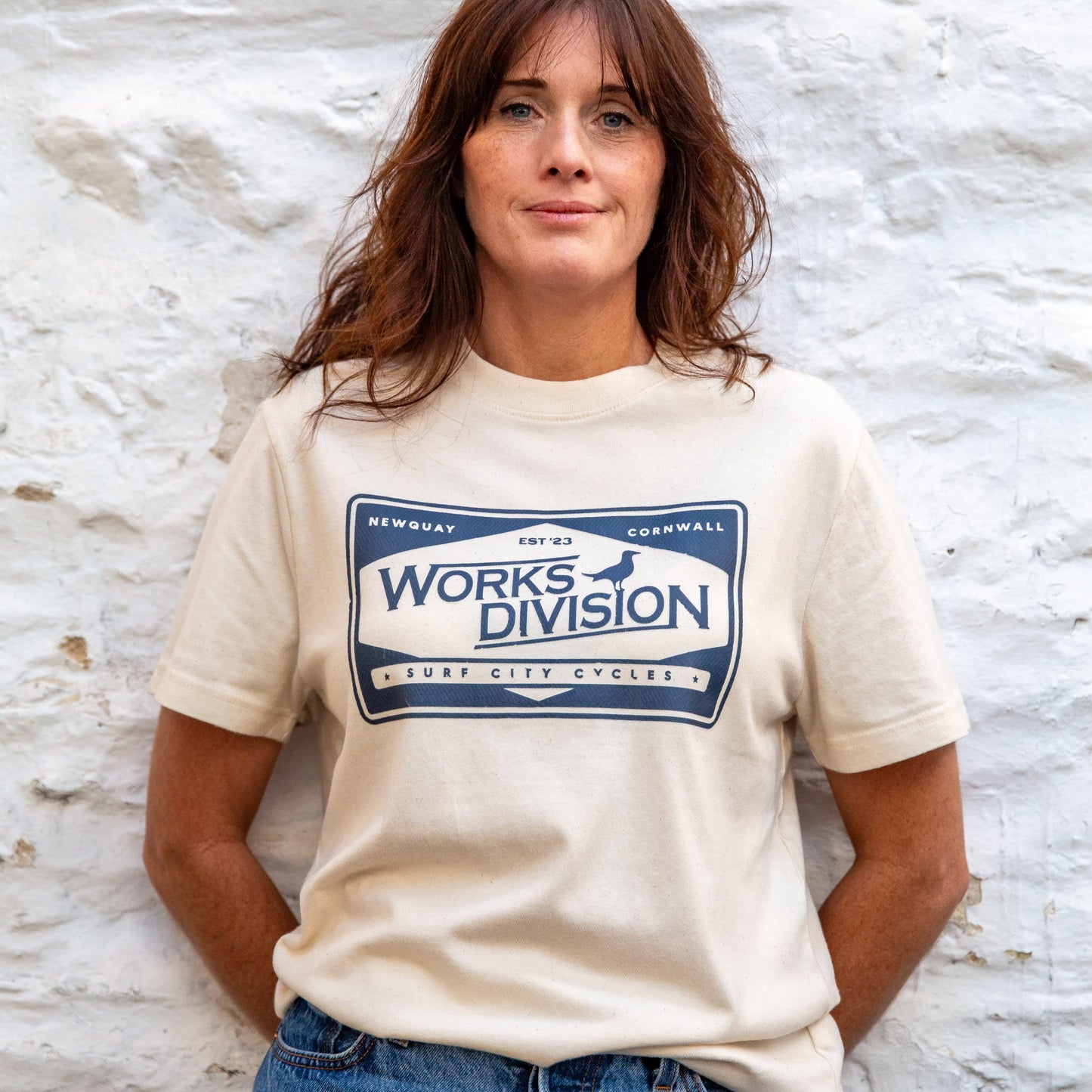he Works Division Heavy Utility Tee in Natural, showing the relaxed unisex fit on a female model.