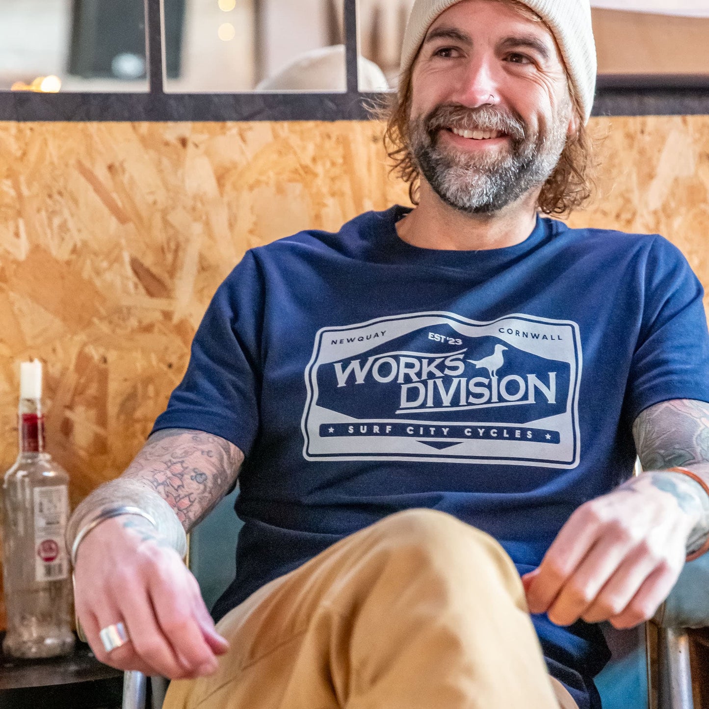 Male model wearing the Navy Works Division Heavy Utility Tee in a relaxed, social setting, showing the drape and fit.
